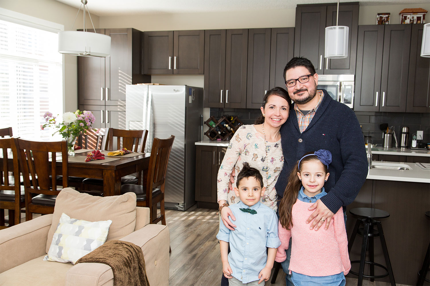 Isabel Echavarria and Andres Gutierrez, together with their children Santi and Sophia, say owning a home gives them a sense of belonging. 